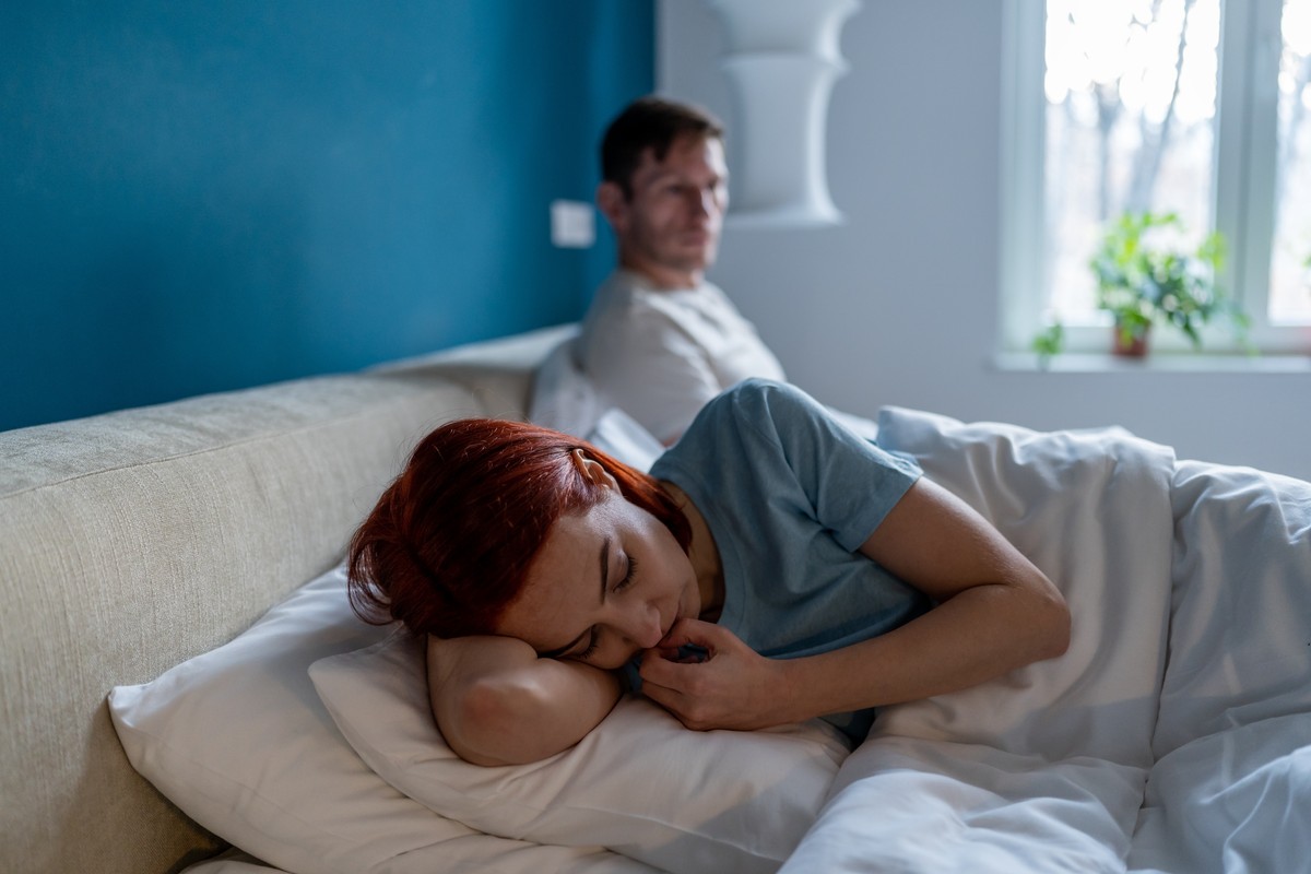 Couple resting in bed during a sleepless night.