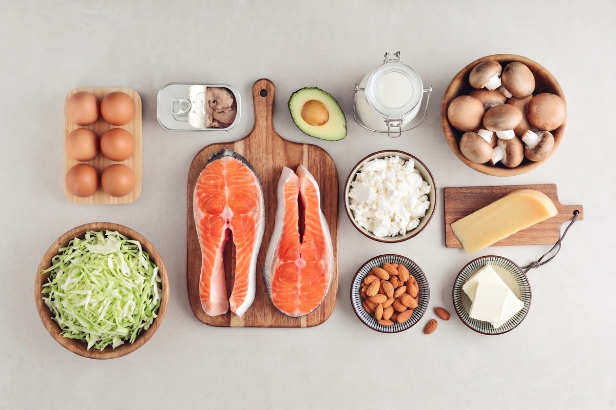Fresh seafood displayed with various ingredients for a meal, including salmon and shellfish.