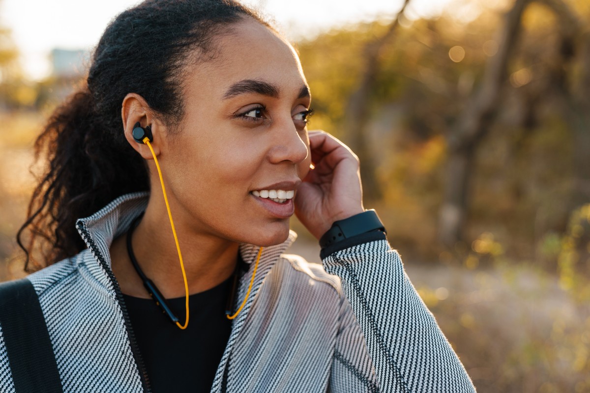 Running athlete listening to headphones.