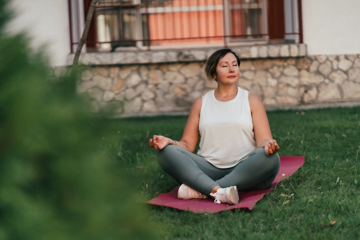 Inspired woman practicing yoga outdoors.